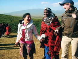 Maasai woman welcomes U.S. students Rachael Wolff (l.) and Caitlin Rooke to her village.