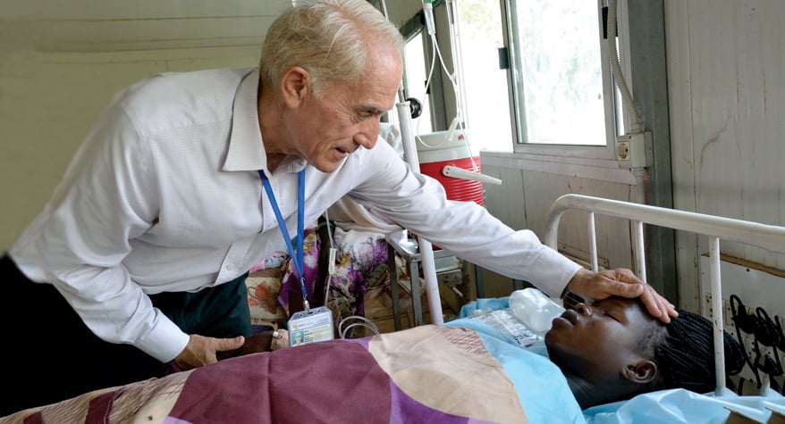 Father Michael Bassano, M.M. with a patient (South Sudan)