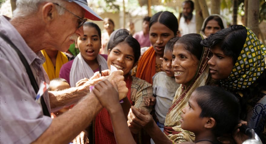 Father Bob McCahill, M.M. with people (Bangladesh)