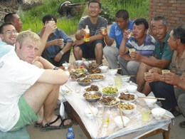 Victor Ingall's '12 (Mobile) and Coin Wen '12 (Sacramento) sit down for lunch with firshermen in a rural village in Northern China.