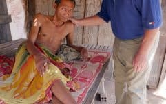 Father Kevin Conroy comforts a man suffering from mental illness (Cambodia) Father Kevin Conroy comforts a man suffering from mental illness (Cambodia)