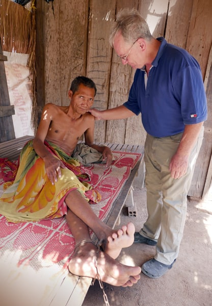 Father Kevin Conroy comforts a man suffering from mental illness (Cambodia) Father Kevin Conroy comforts a man suffering from mental illness (Cambodia)