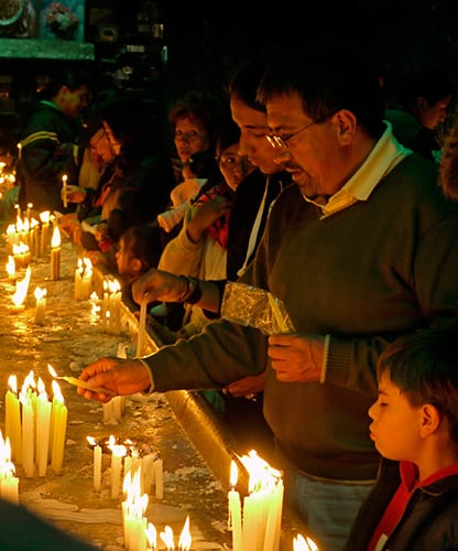 Devotees lighting candles (Bolivia)